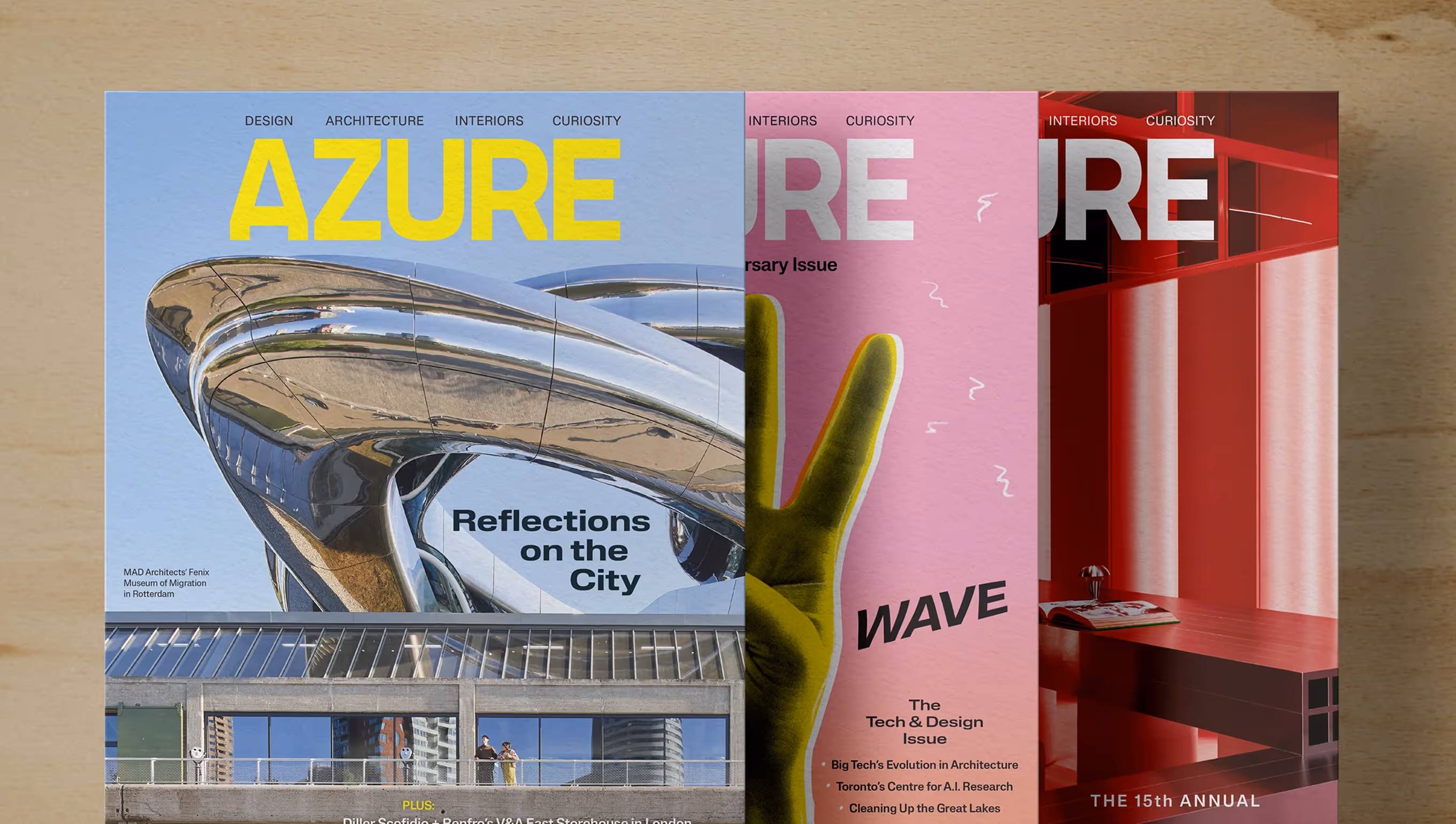 Three overlapping Azure magazine covers featuring modern architecture, a yellow hand making a peace sign on pink background, and a red interior design scene.