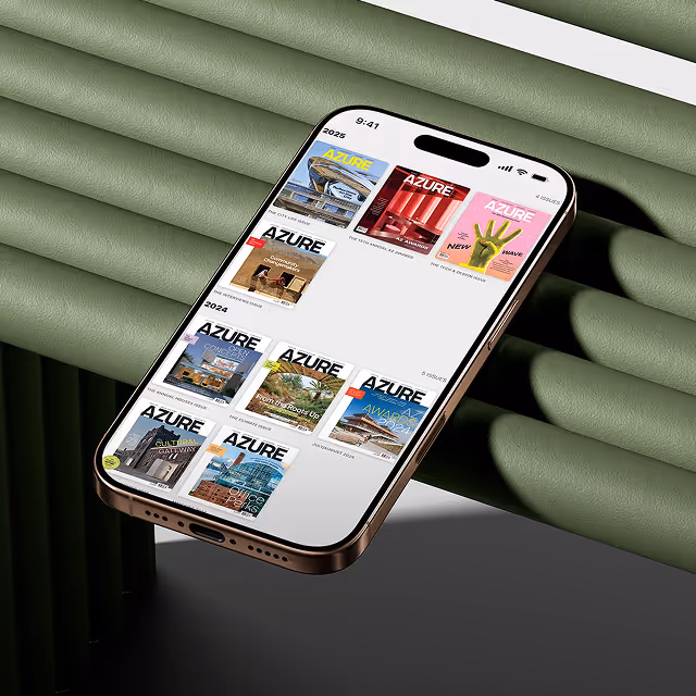 Smartphone displaying digital covers of Azure magazines floating above a green ribbed surface.