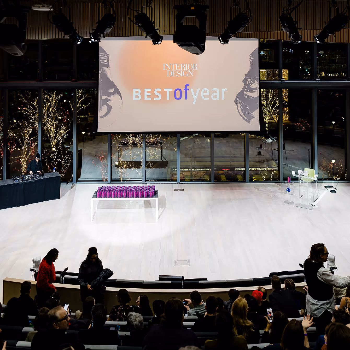 Audience seated in a modern auditorium facing a large screen displaying 'INTERIOR DESIGN BEST of year' during an award event.