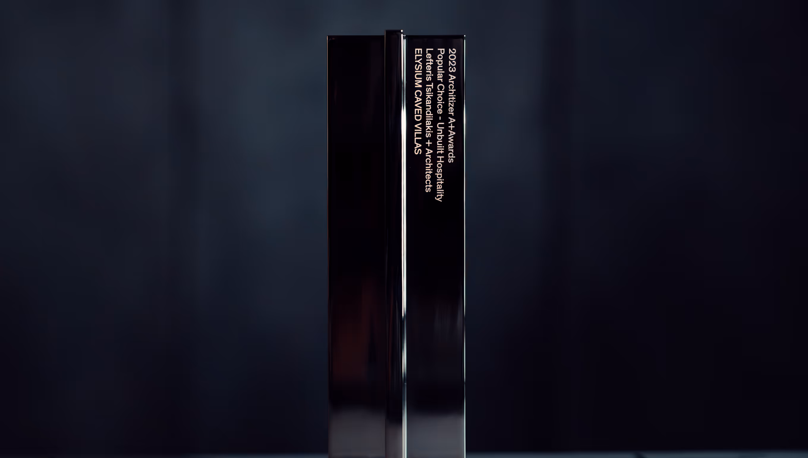 Tall black reflective award trophy with inscription for 2023 Architizer A+ Awards Popular Choice for Ubbulli Hospitality by Lefteris Tsikandilakis + Architects, Elysium Caved Villas.