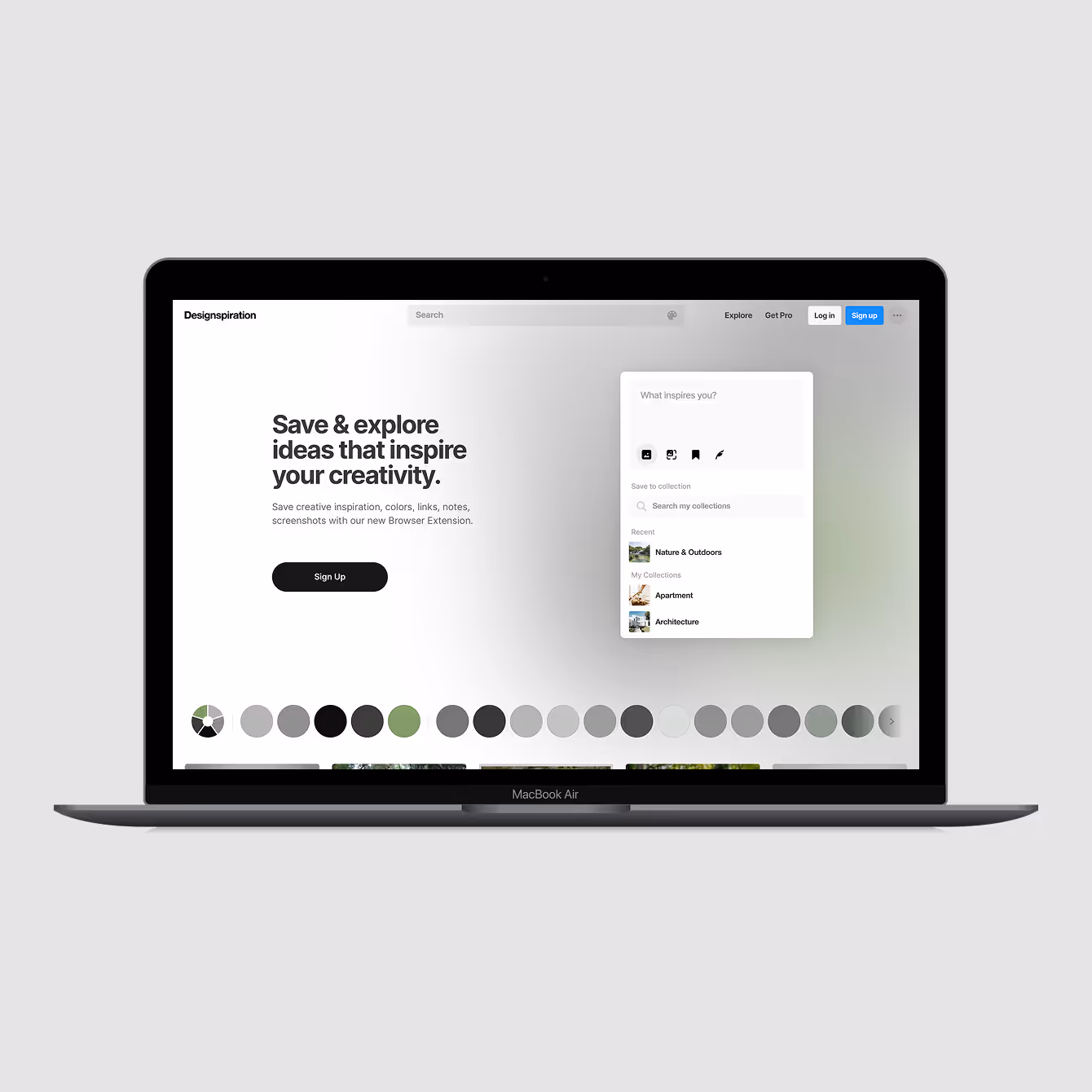 MacBook Air displaying Designspiration website with text to save and explore creative ideas and a sign-up button.