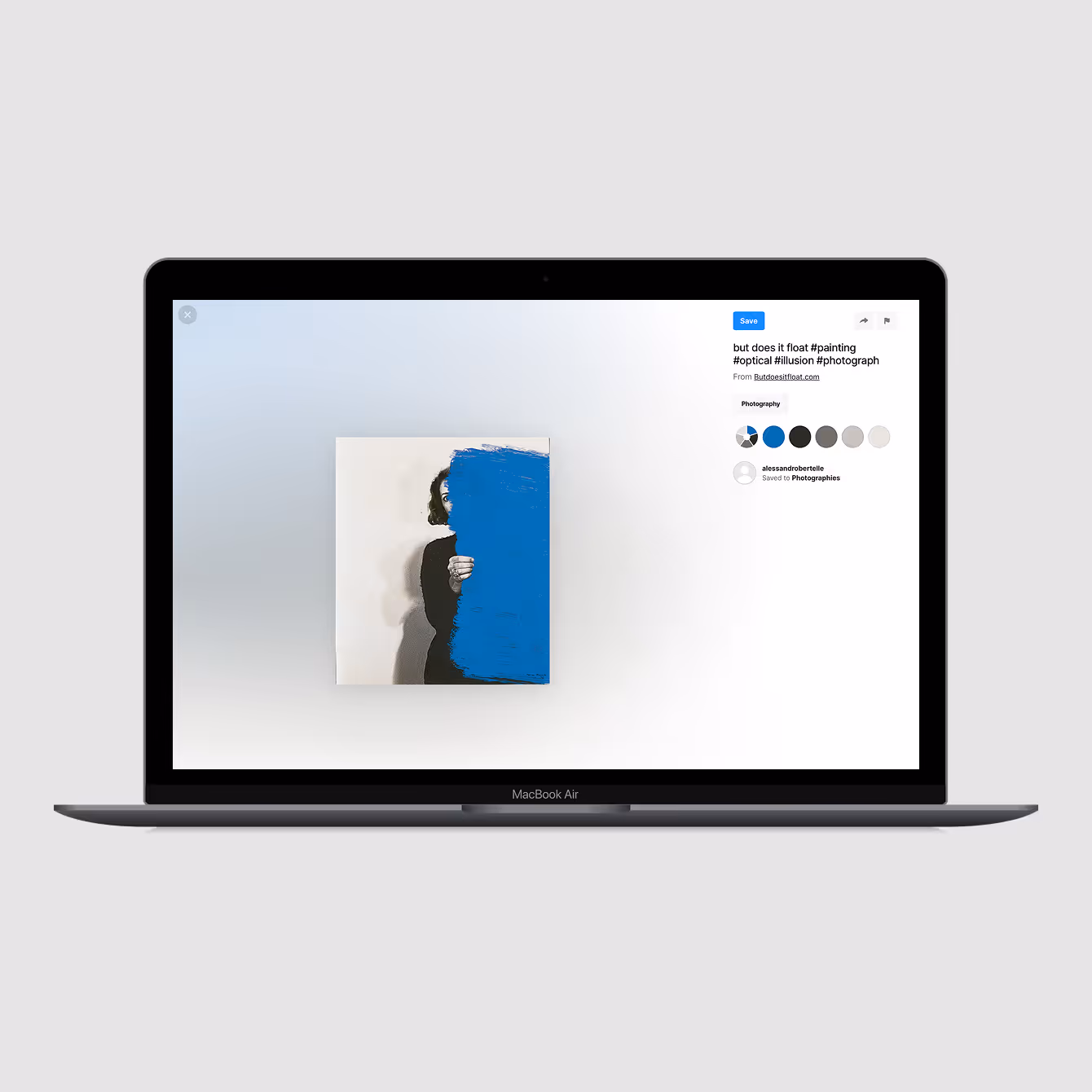 MacBook Air displaying an image of a person partially obscured by a large blue paint stroke covering half of their face and torso.