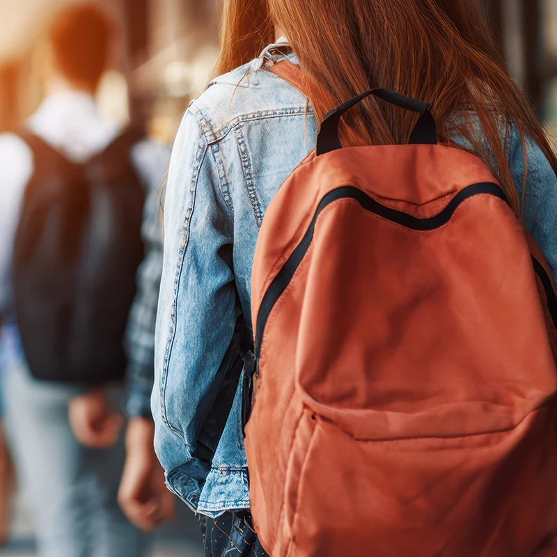 Students in the hall with bookbags.