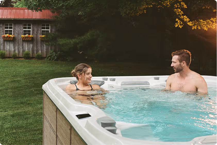 Couple sitting in a Sundance swim spa talking