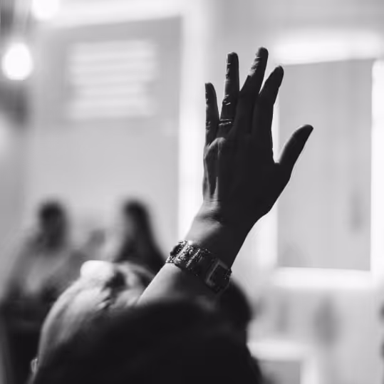 a person raising their hands in the air