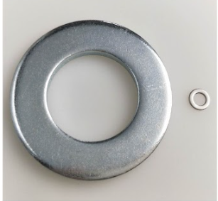 A large silver flat washer next to a much smaller silver flat washer on a white background.