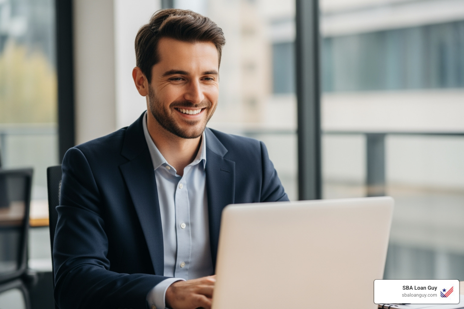 friendly loan expert smiling at a laptop - SBA Loan Specialists friendly loan expert smiling at a laptop - SBA Loan Specialists