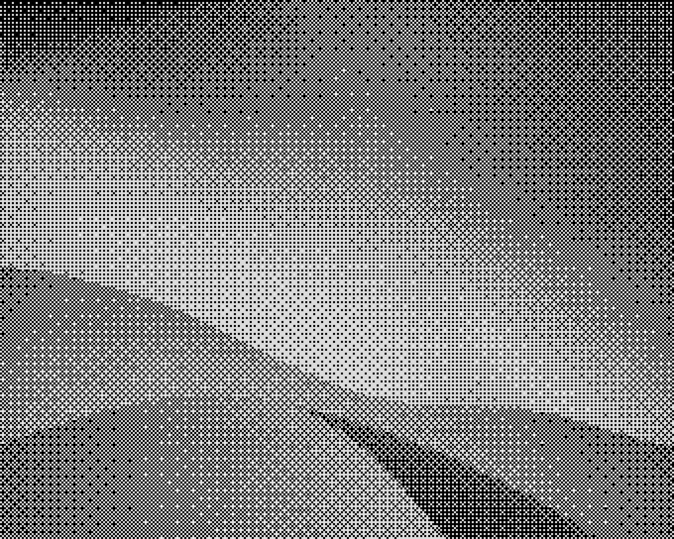 Indoor event setup with a small stage, a person working at a table with laptops, audio equipment, and a projector screen with blue curtains in the background.