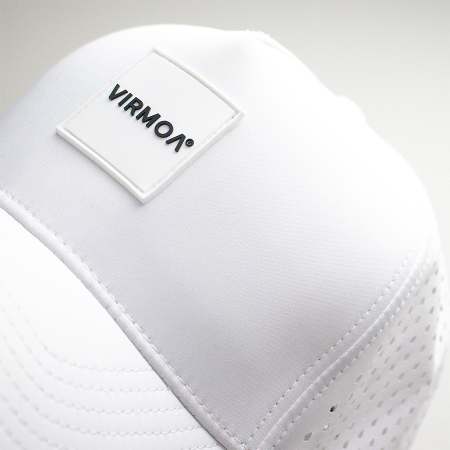 Close-up of a white hat with a stitched patch labeled VIRMOA.