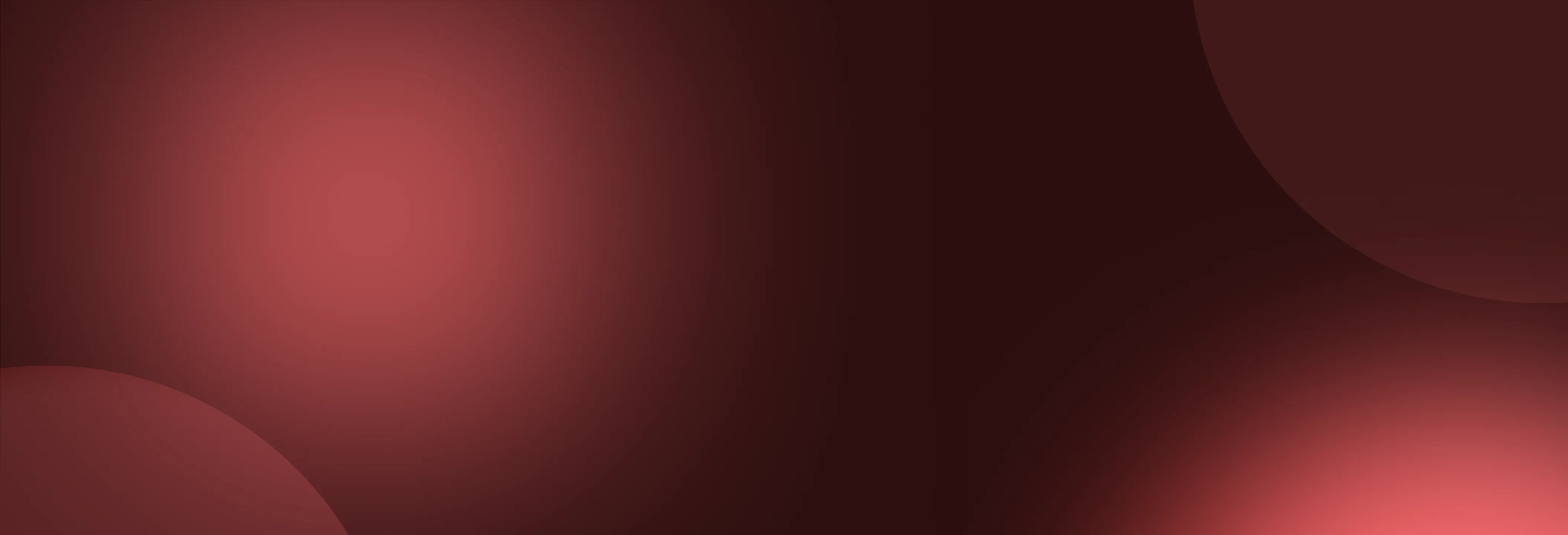 Abstract blurred background with large overlapping dark red and pink circles.