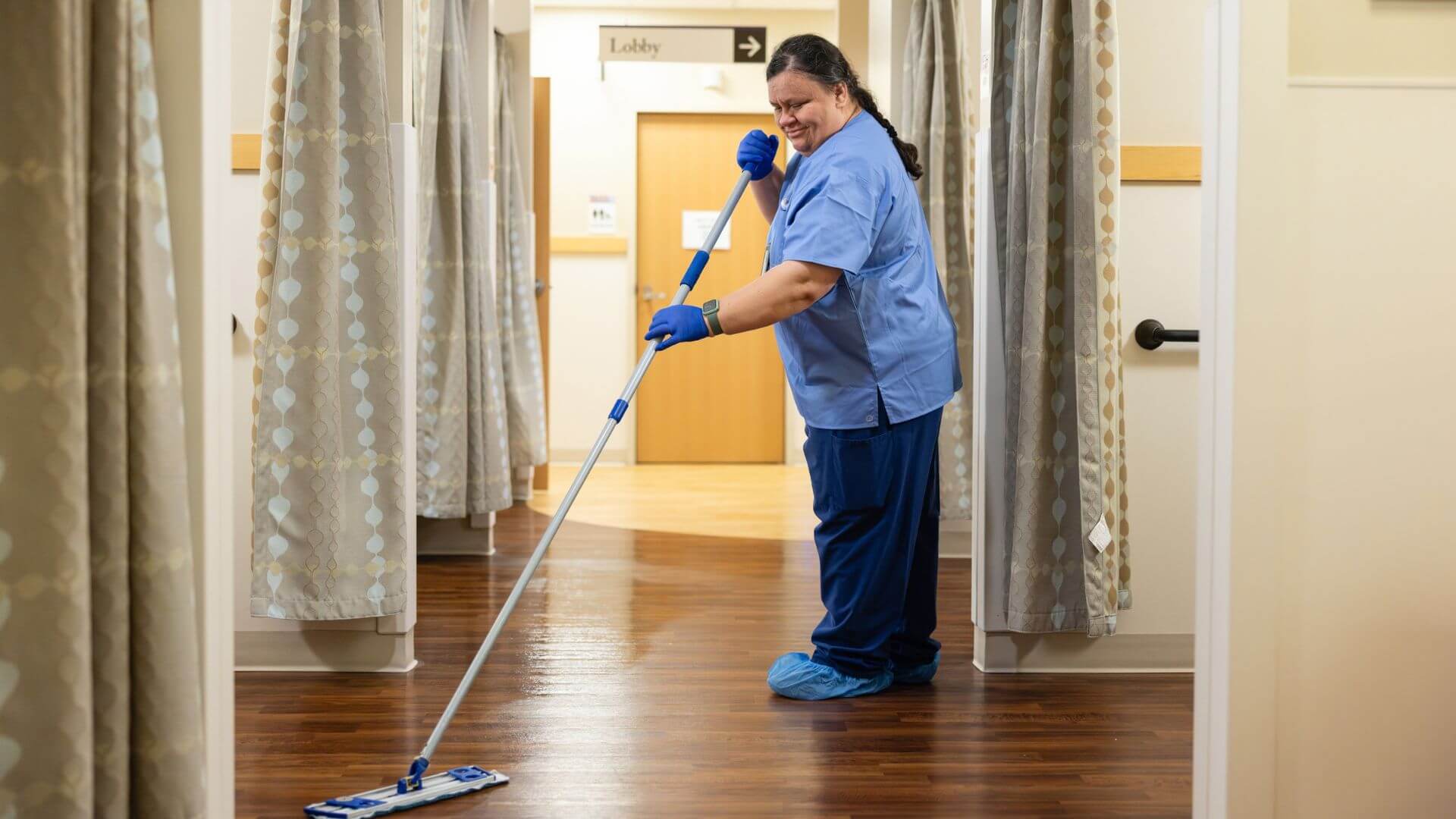A janitor cleaning a medical facility to healthcare cleaning standards