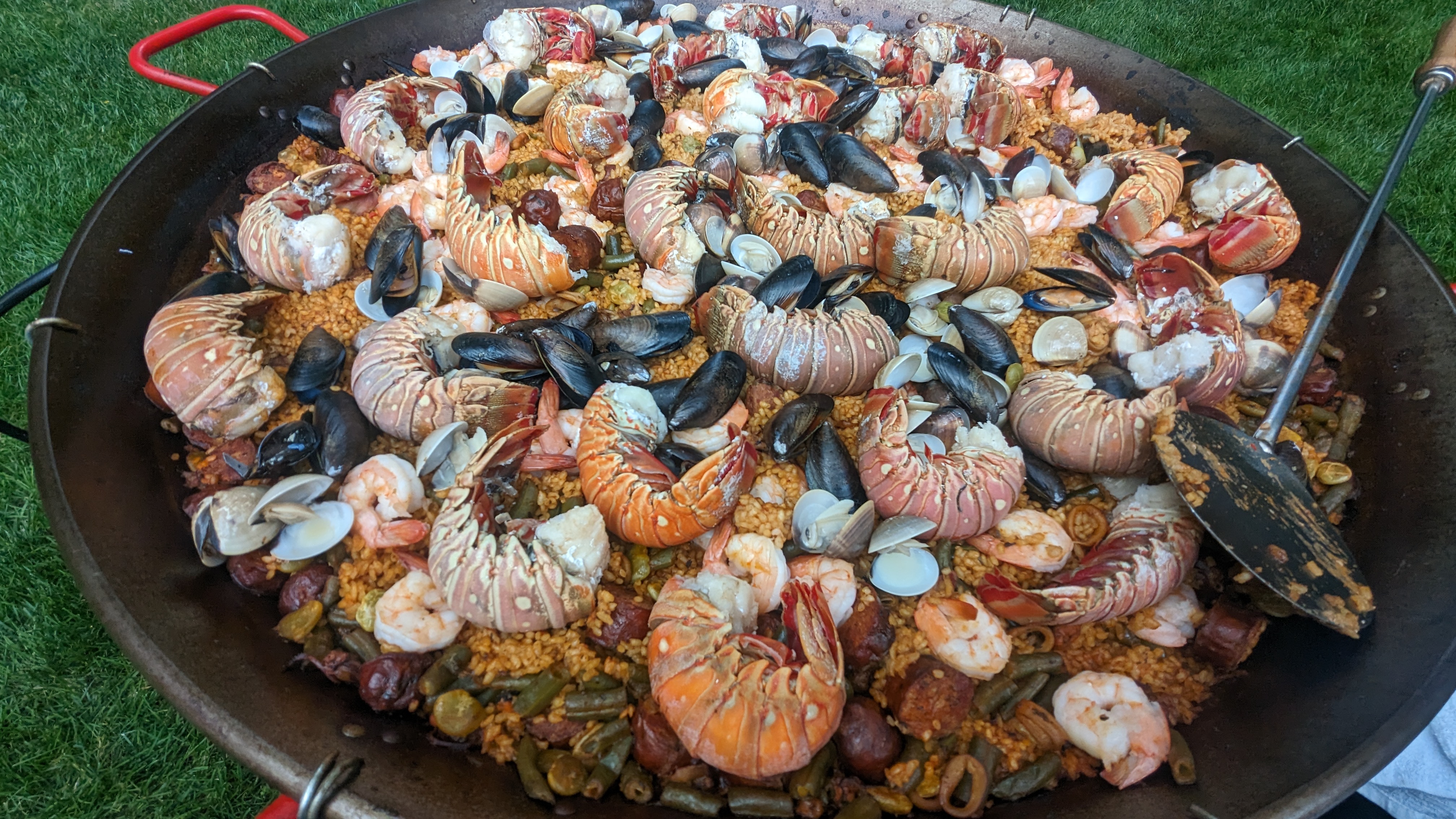 Seafood paella prepared on-site at catering event