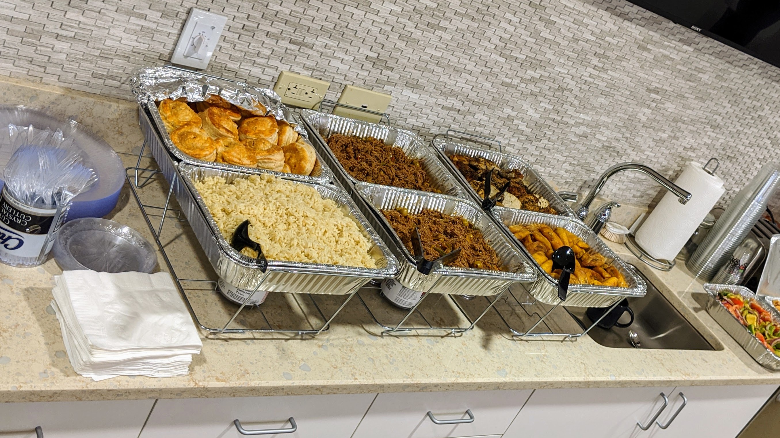 Cuban food catering buffet setup in medical office break room