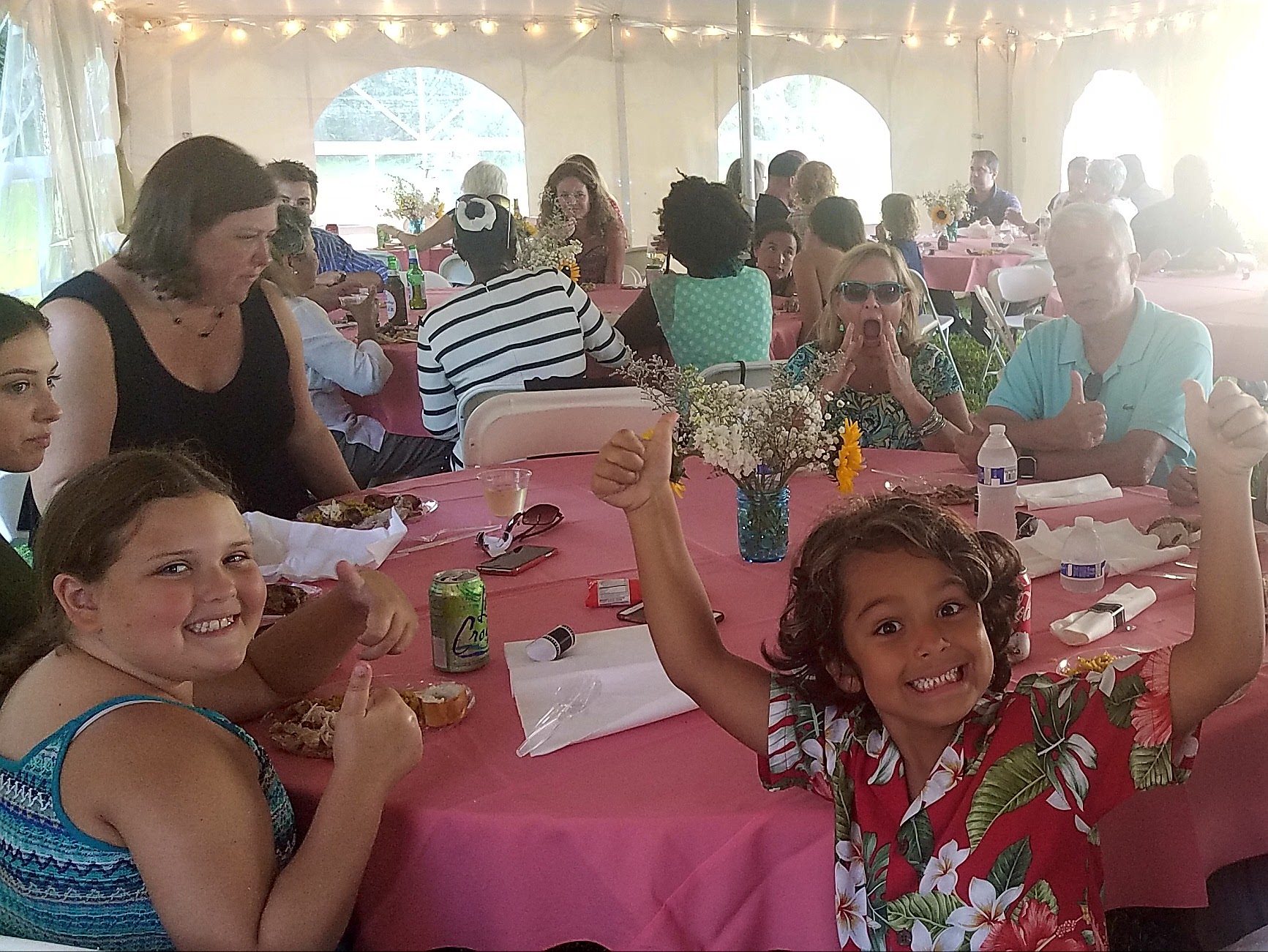 Guests enjoying Cuban food at catered tented event
