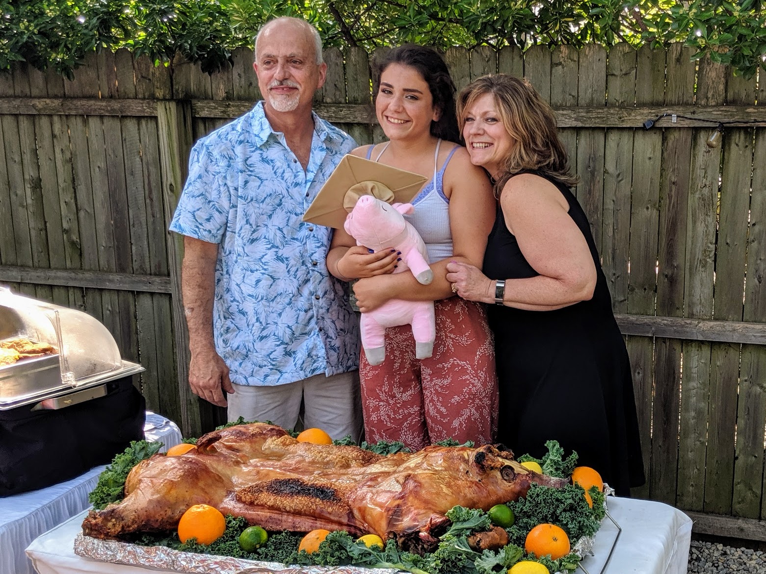 Cuban whole roast pig display with event hosts