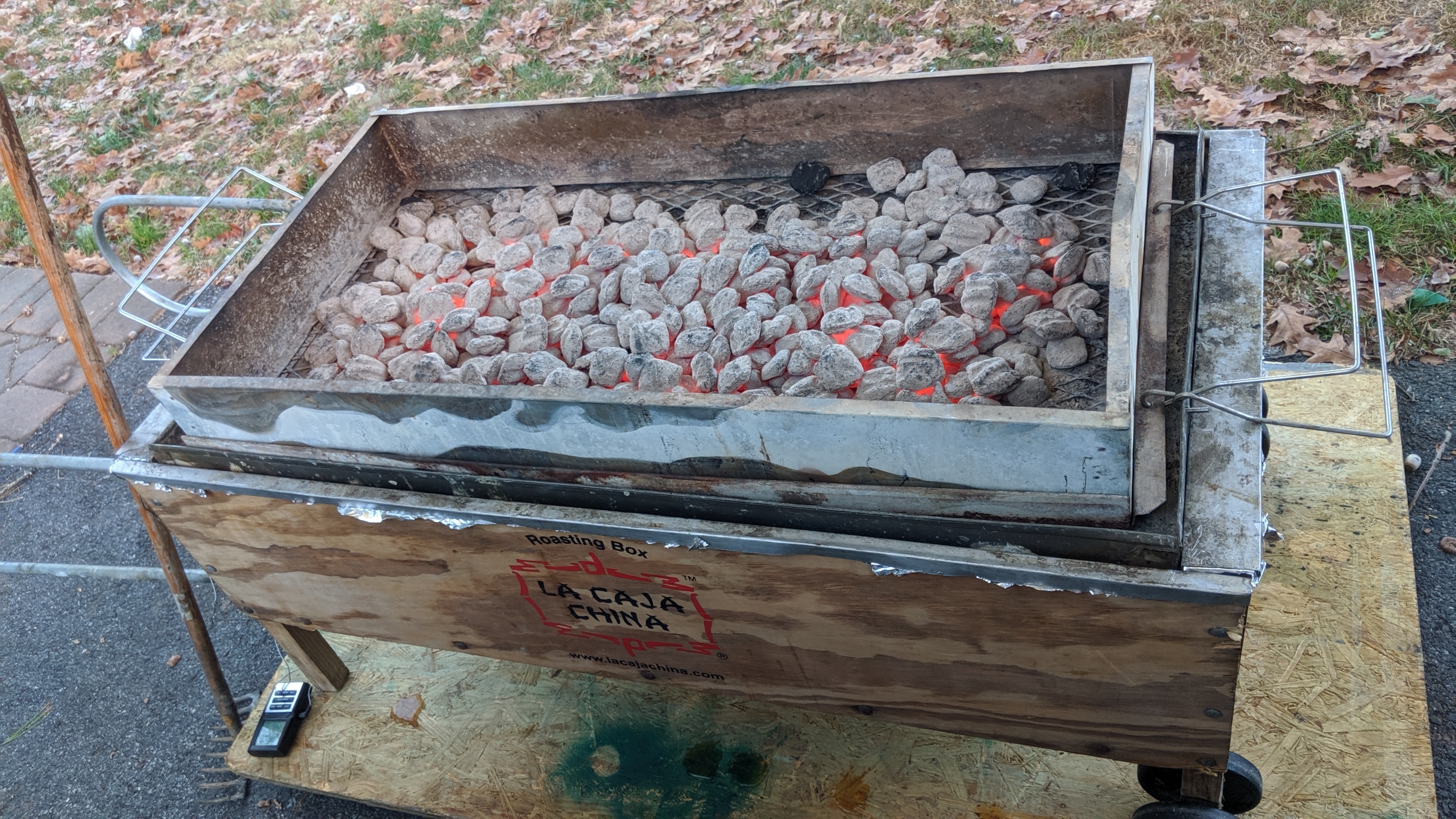 Caja China roasting box set up cooking whole pig in backyard