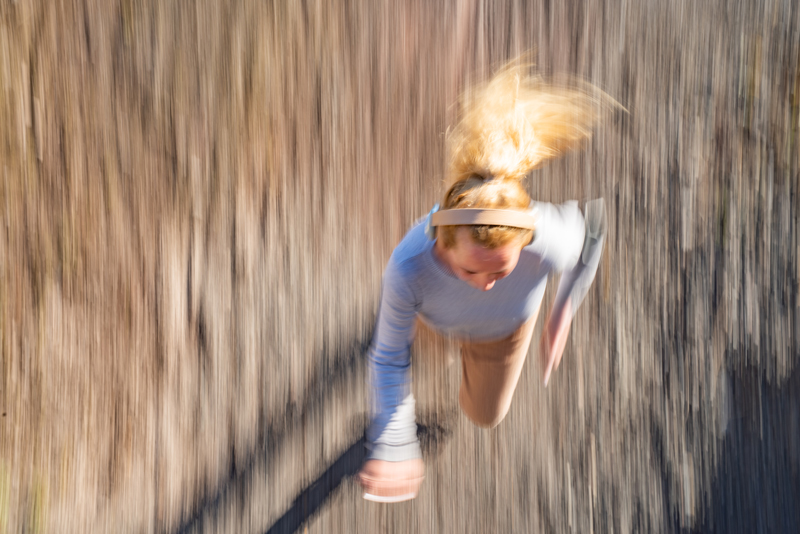 Energetic young couple, one of which is jumping over the sofa, representing joy and excitement of owning their first home faster.
