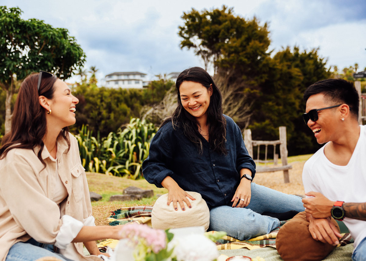 Young couple moving into their new home, moving boxes into an empty living room, excited with their first home, all possible through Aera.