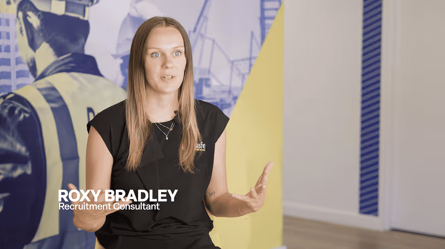 Close-up of a blue and yellow Rigsafe vehicle with 'Lifting Solutions' and safety slogan on the door.