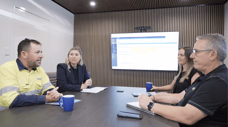 Close-up of a blue and yellow Rigsafe vehicle with 'Lifting Solutions' and safety slogan on the door.