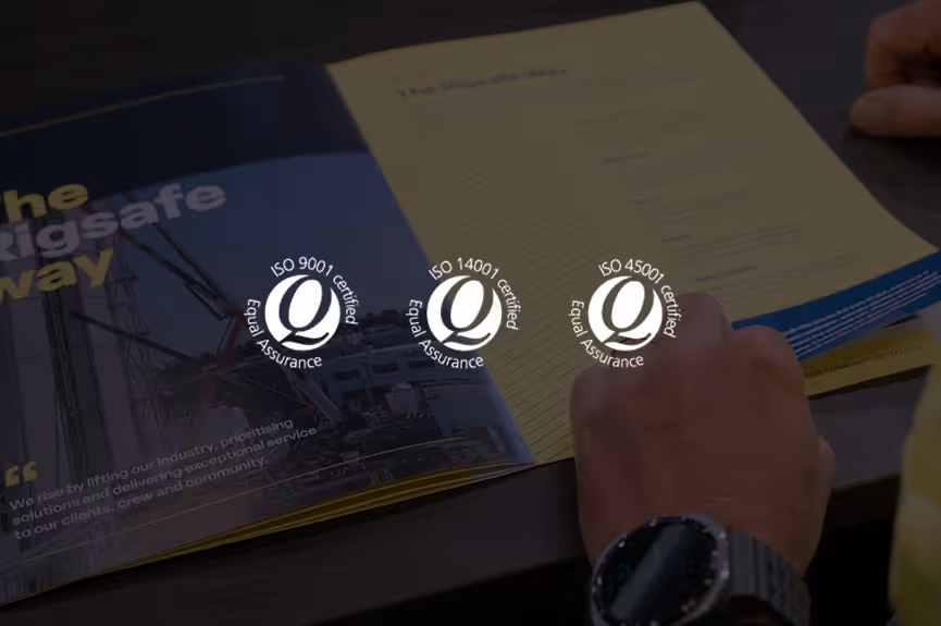 Open brochure on table with hands holding it, displaying ISO 9001, ISO 14001, and ISO 45001 Equal Assurance certified logos.