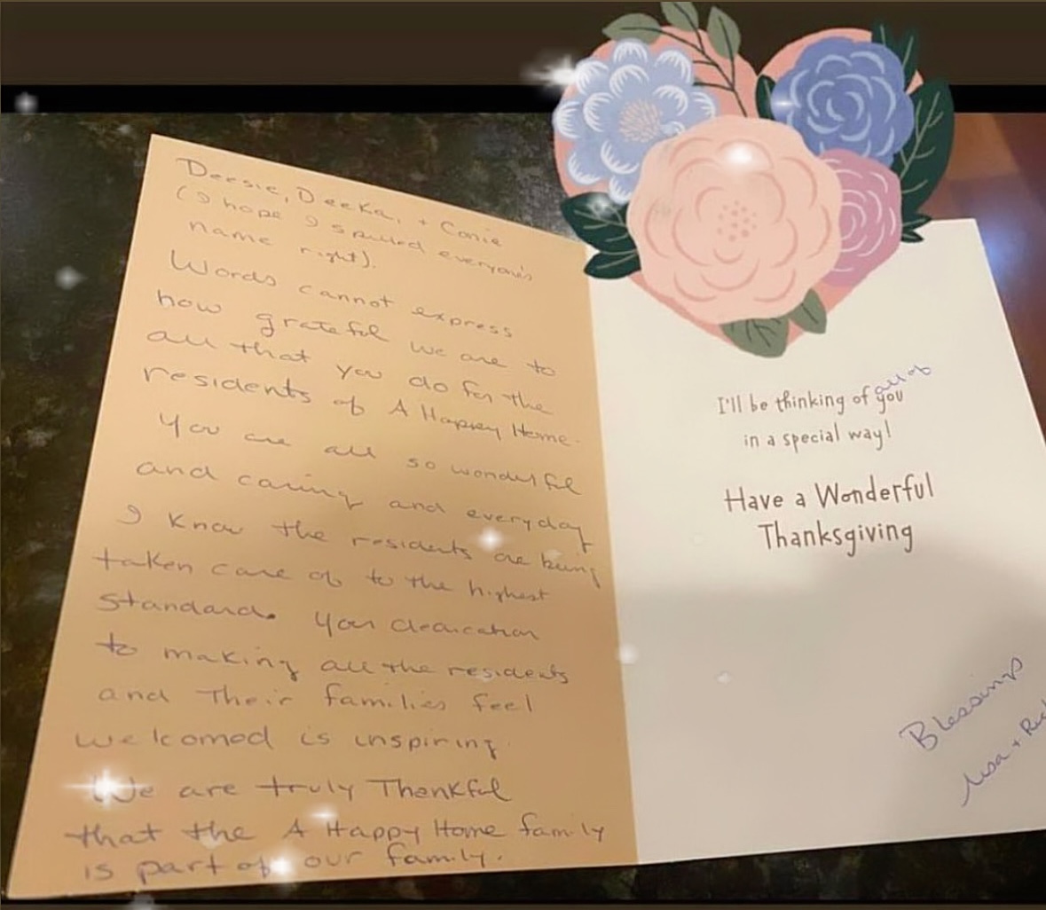 Open Thanksgiving card with handwritten message on left and printed text with floral decoration on right.