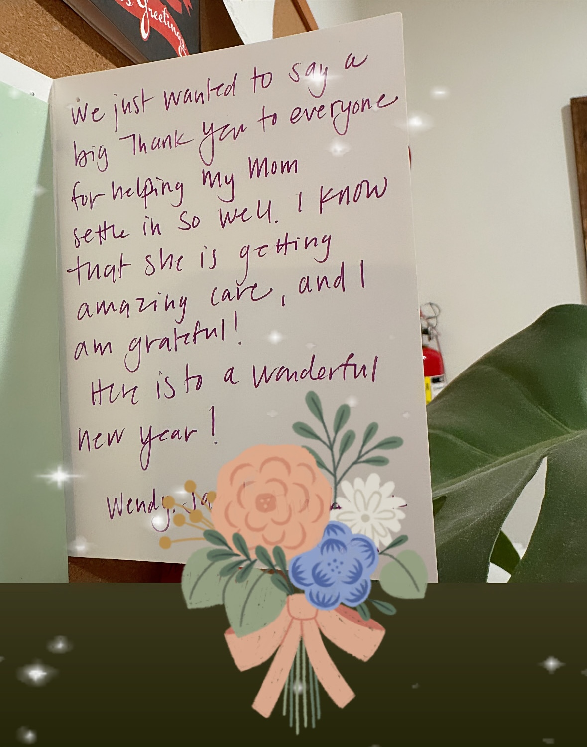 Handwritten note expressing gratitude for care given to the writer's mother, wishing a wonderful new year, decorated with an illustrated flower bouquet at the bottom.