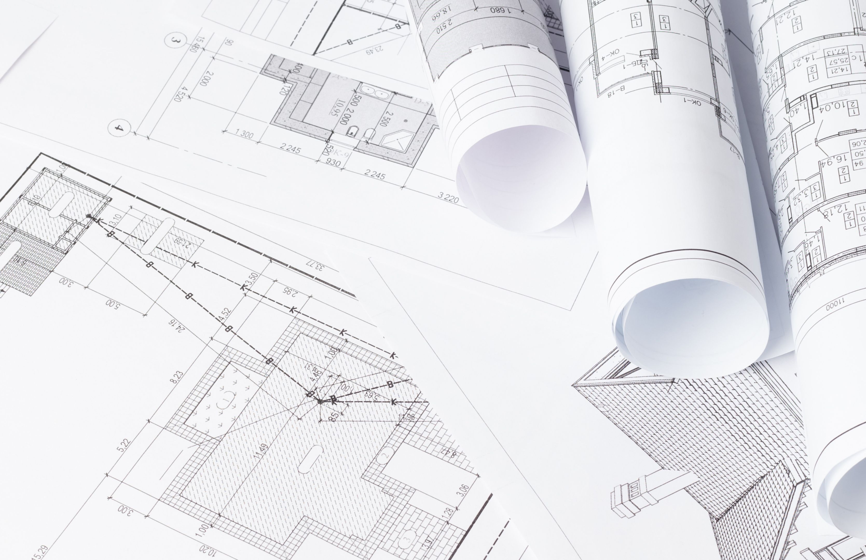 Construction shop drawings are laid out on a table.