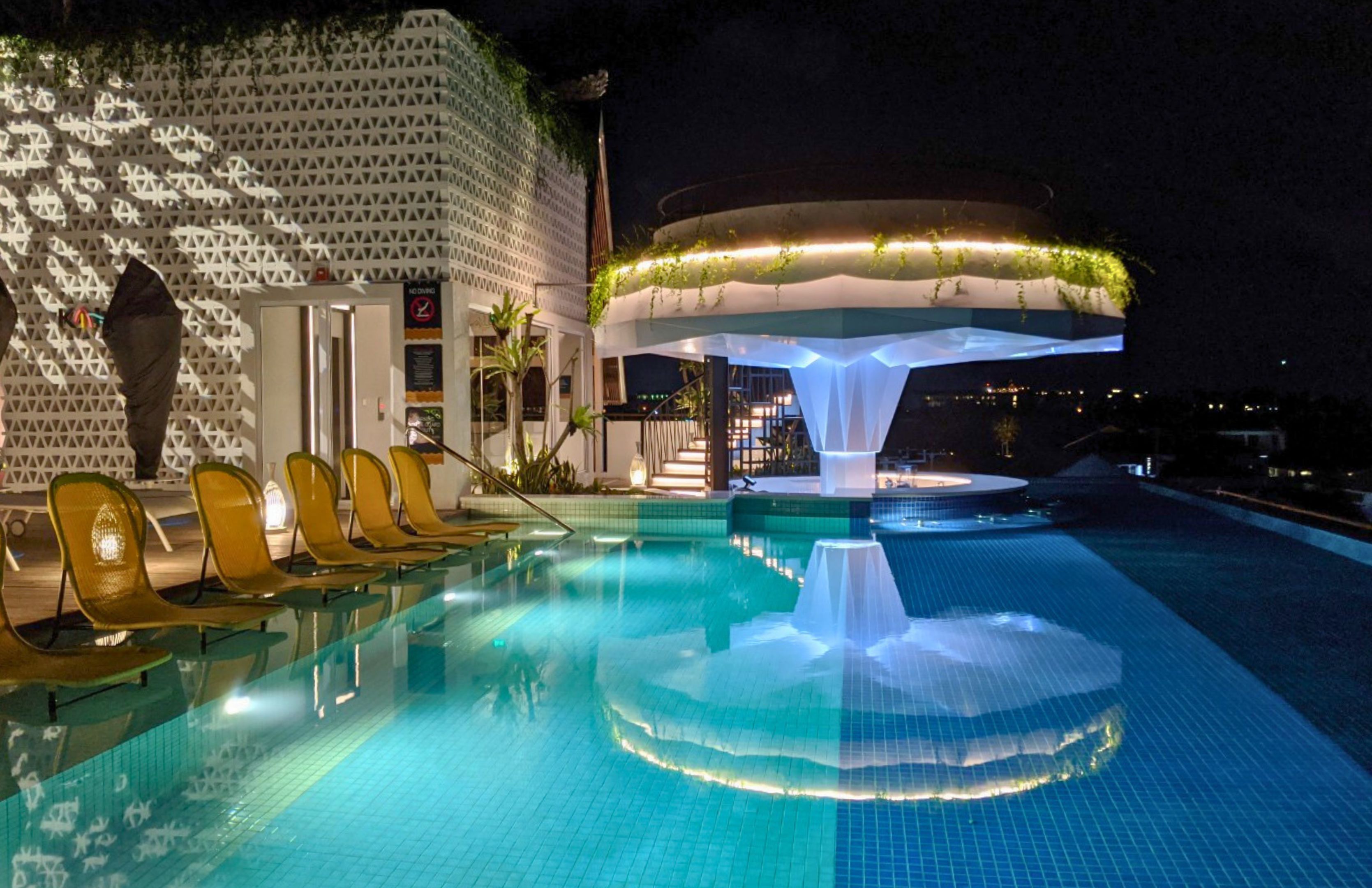 The rooftop pool and sunken bar at the Aloft Seminyak Bali — constructed out of stainless steel and finished in glass mosaic.