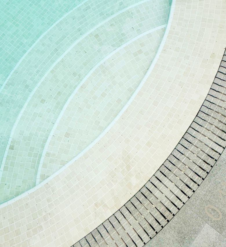 The Arcadia swimming pool steps curve in beautiful arcs down into the cool blue water.