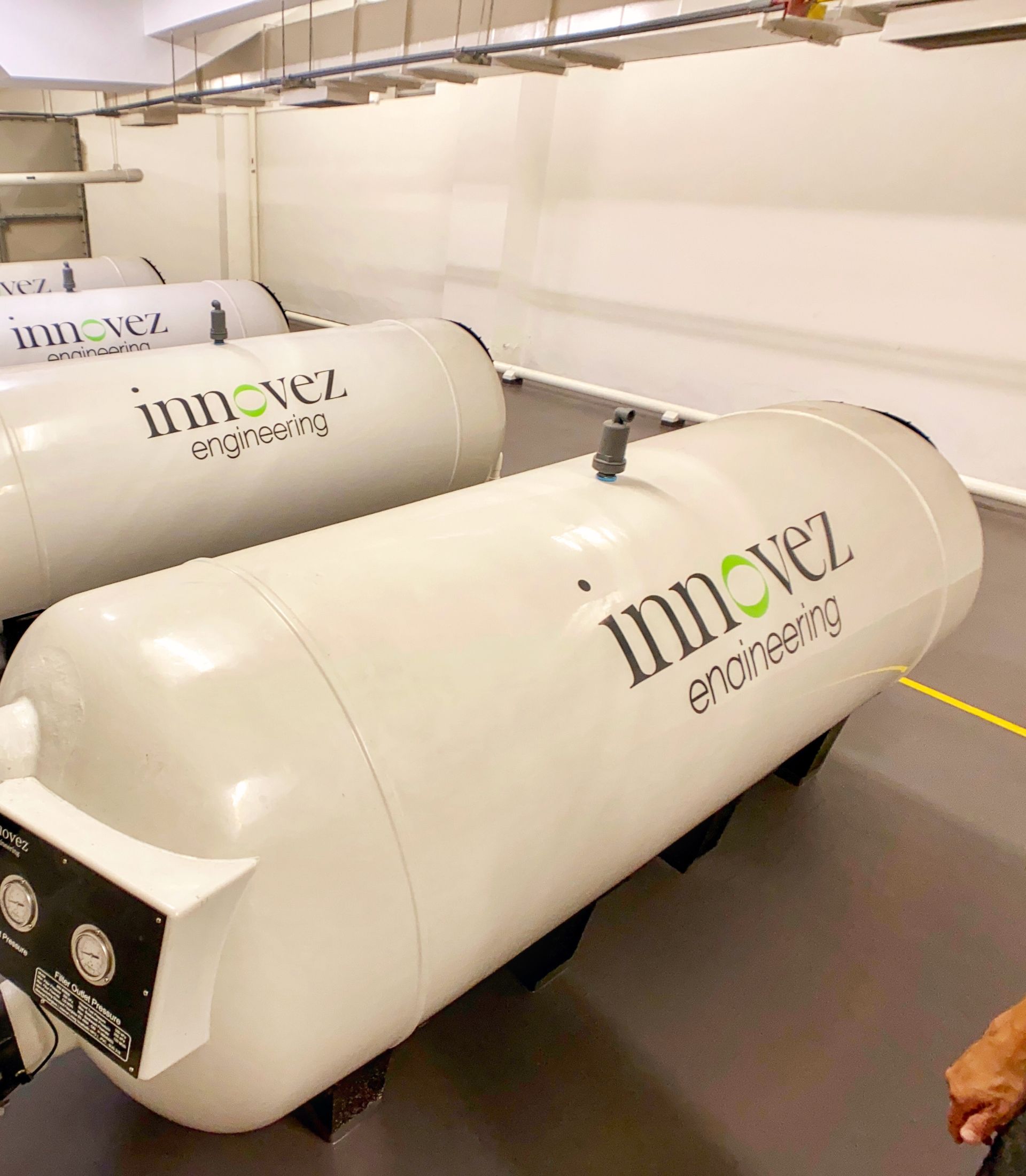 Innovez Engineering high-rate commercial pool filters are lined up in an orderly fashion in the UWCSEA East Campus pump room.