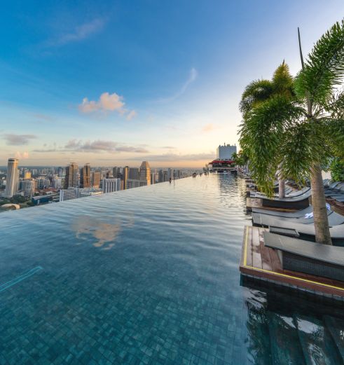 The SkyPark pool at Marina Bay Sands, constructed by Innovez Engineering. The Singapore skyline spreads out from over the infinity edge.