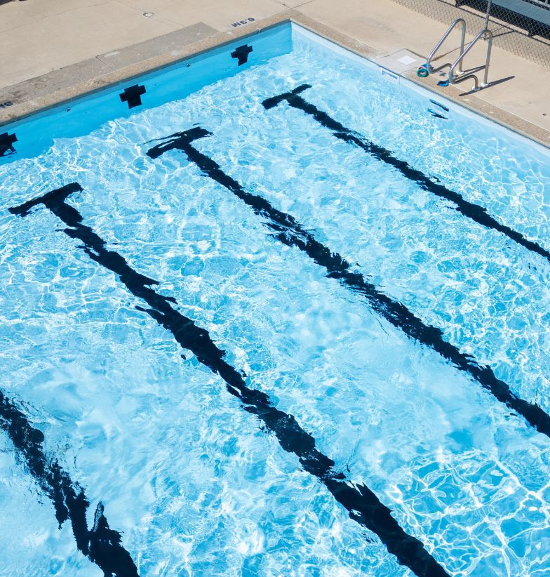 Top-down view of a swimming pool with black PVC lane markers.