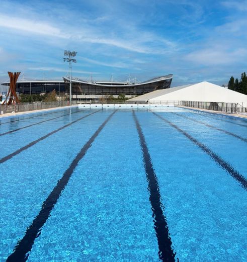 An Olympic-sized swimming pool stretches out. It is finished with PVC pool membranes.