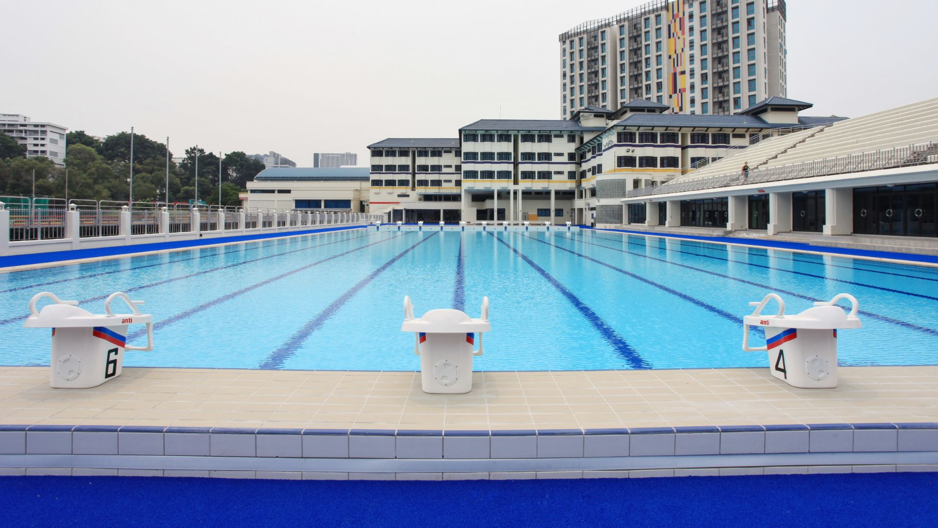 Close-up of starting blocks facing forward at the Anglo-Chinese School Independent competition pool. Large numbers have been printed in black on each block.
