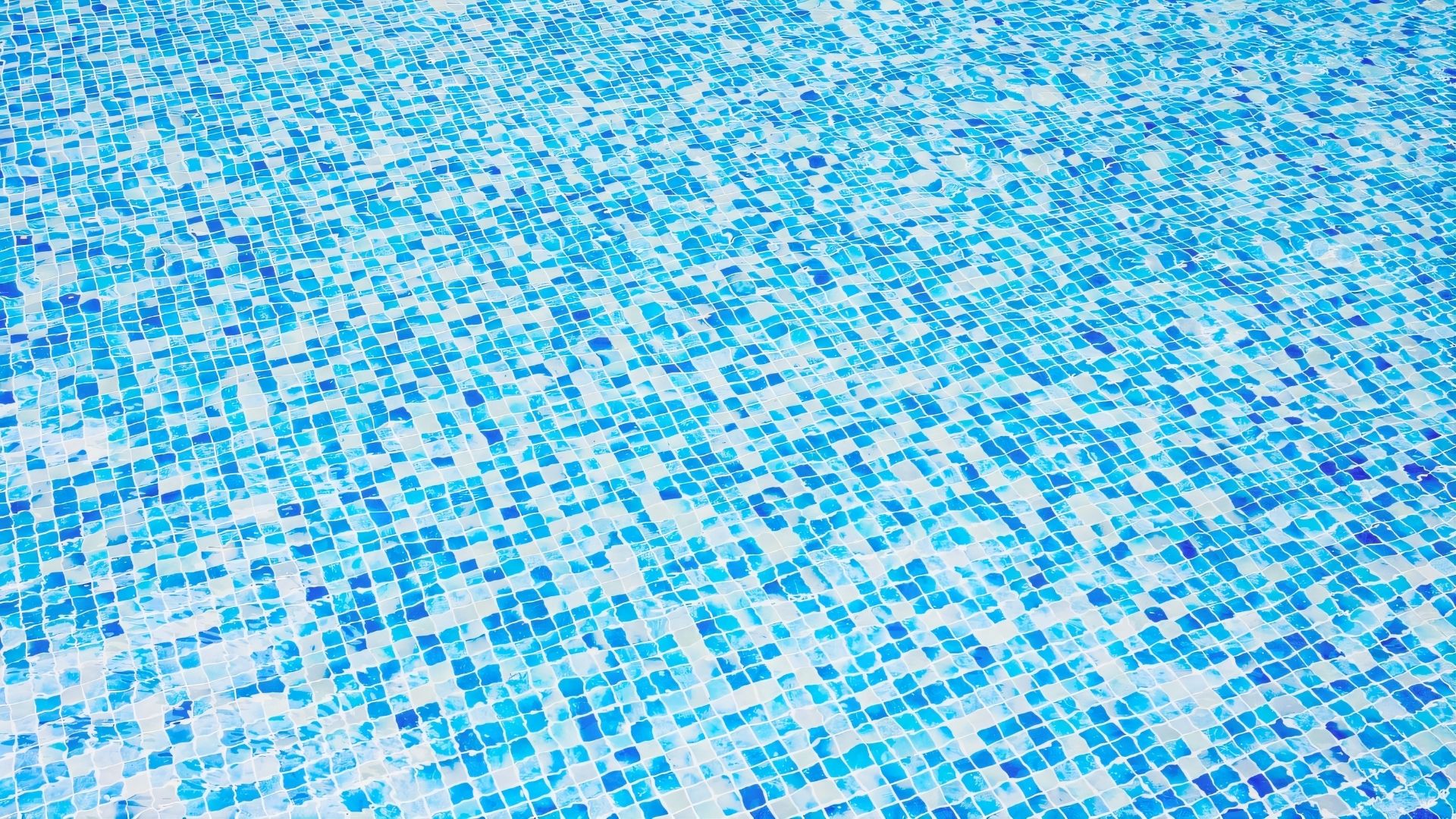 Close-up of the blue and white mosaic tiles at Costa Rhu condominium's swimming pool.