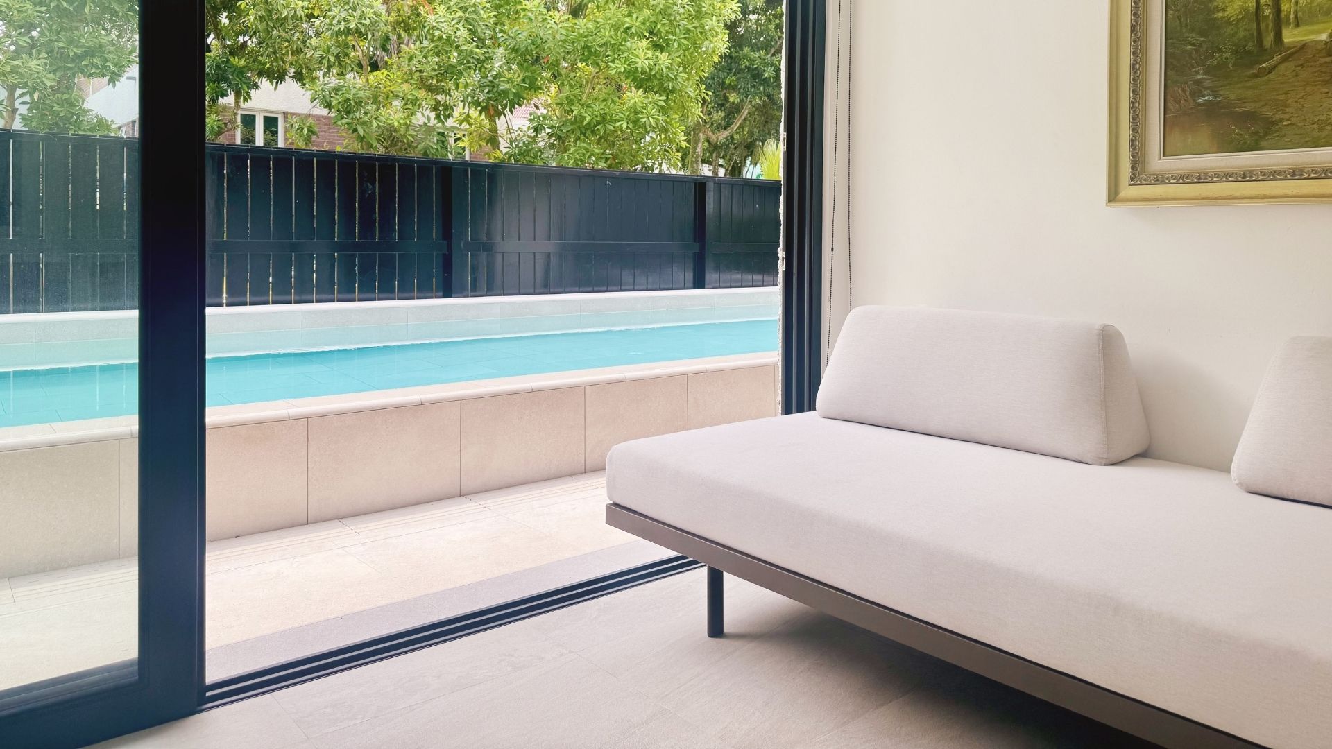Beautiful lap pool finished in Spanish porcelain tiles lines the front porch of the house, offering a fresh visual aesthetic for the eyes when viewed from the living room.