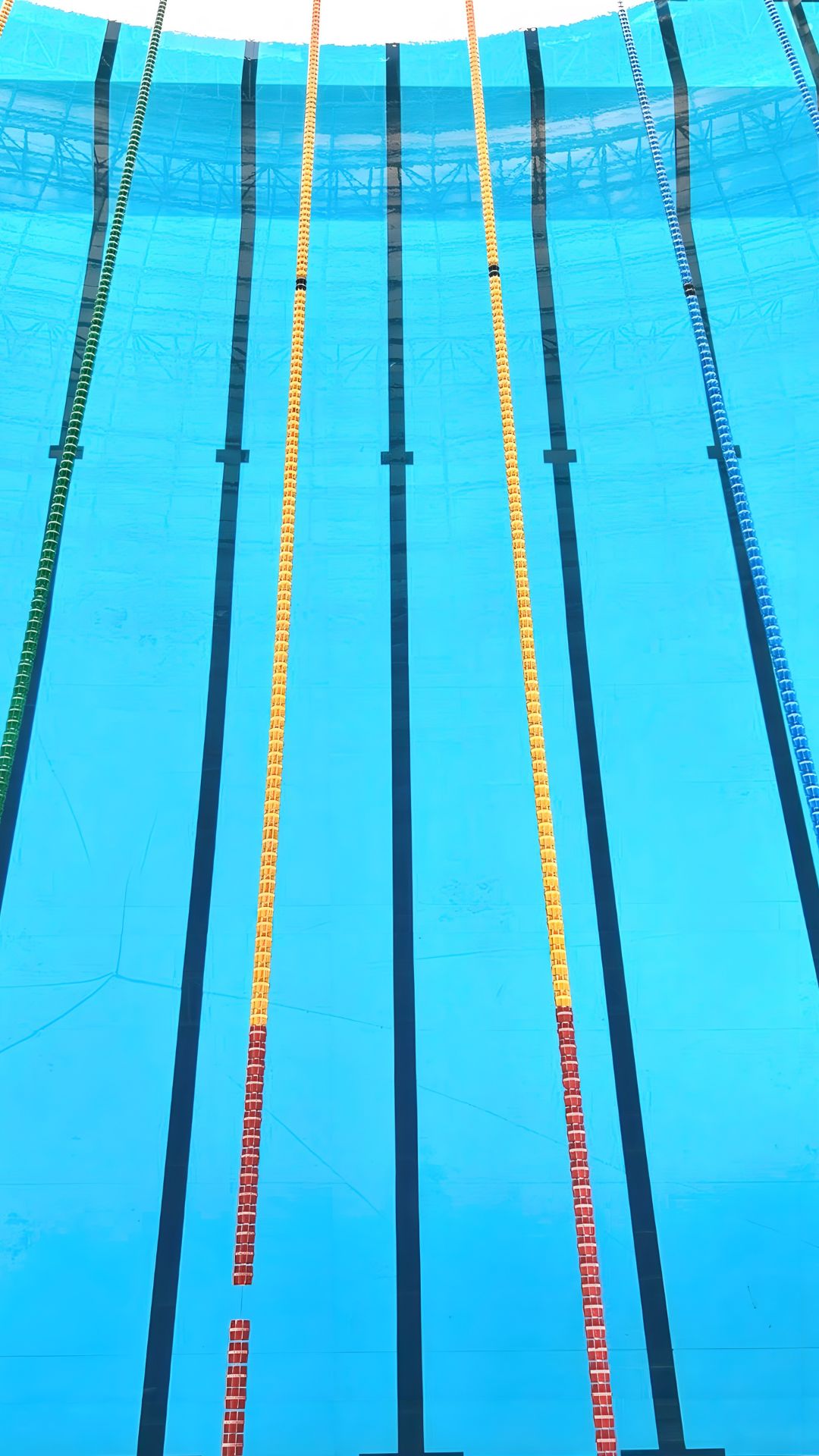 Aerial view of the swimming pool lanes at the Selayang Aquatic Centre. The lanes are divided by bright red and yellow pool ropes.