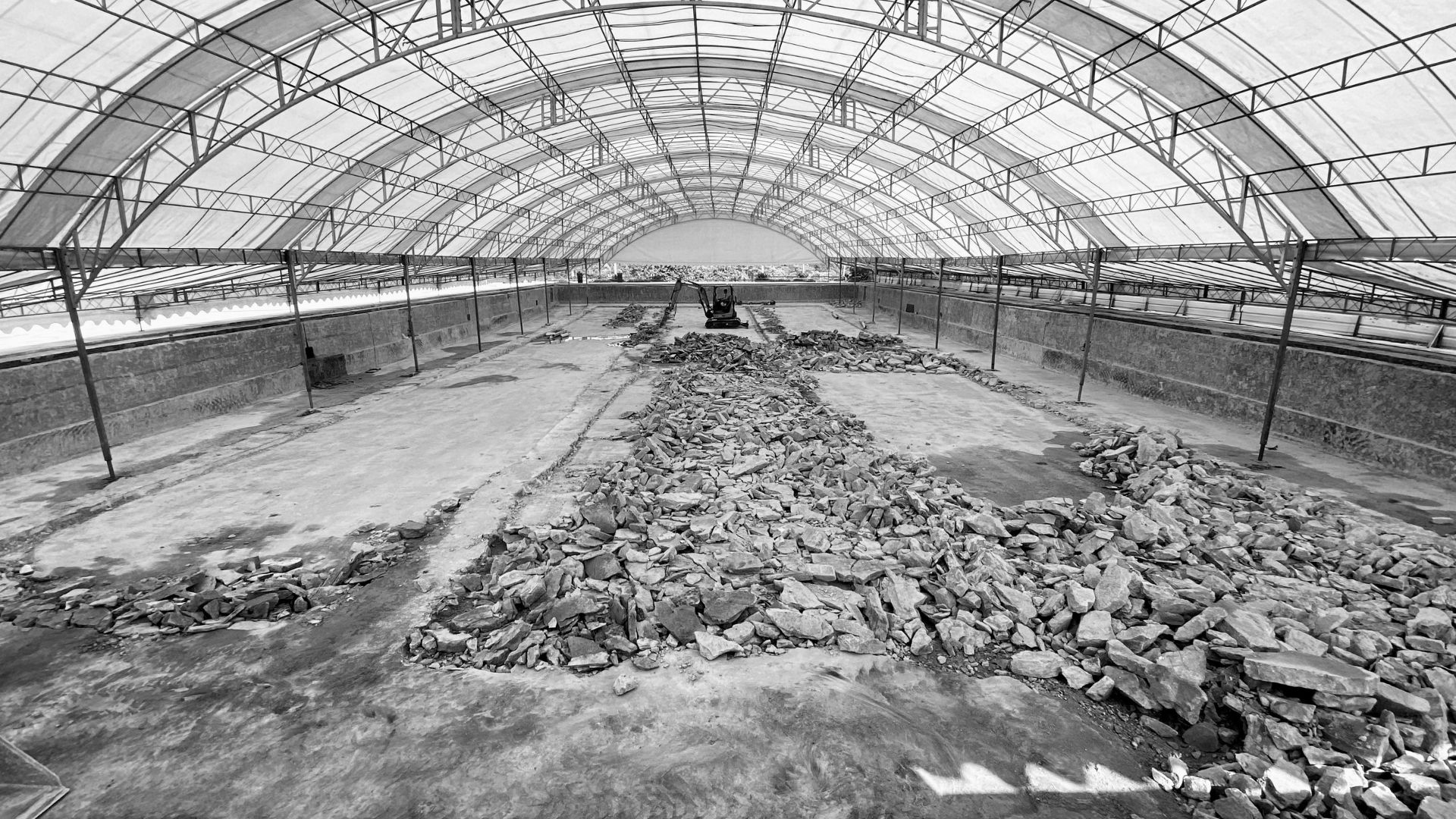Swimming pool demolition works underway at the Singapore Island Country Club, as concrete debris are piled up on the ground. A temporary tentage has been set up to cover the area.