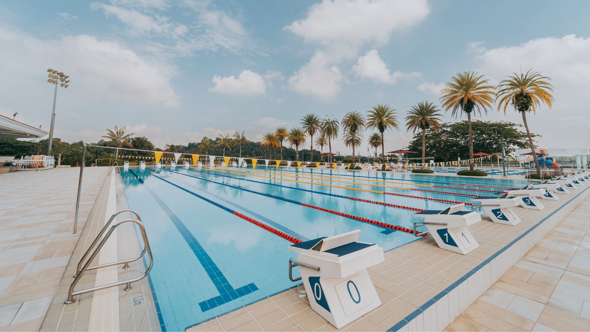 Upgrade works completed for the competition swimming pool at the Singapore Island Country Club. Starting blocks line each end, with grab rails at the edges. The pool is equipped with backstroke flag poles and lane ropes.