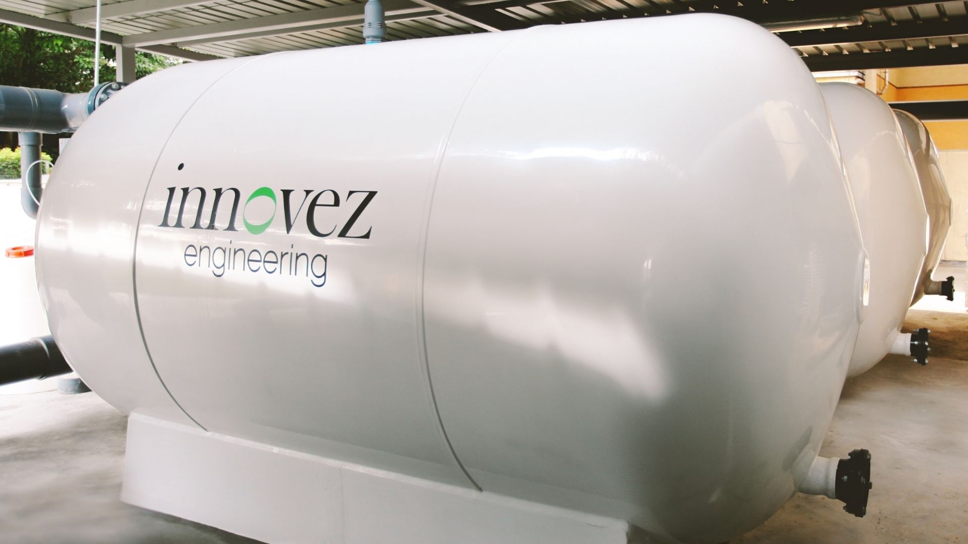 Close-up of the commercial-grade, high-rate sand filters at the Singapore Swimming Club, which look white, clean and new. They have been branded with Innovez Engineering's logo.