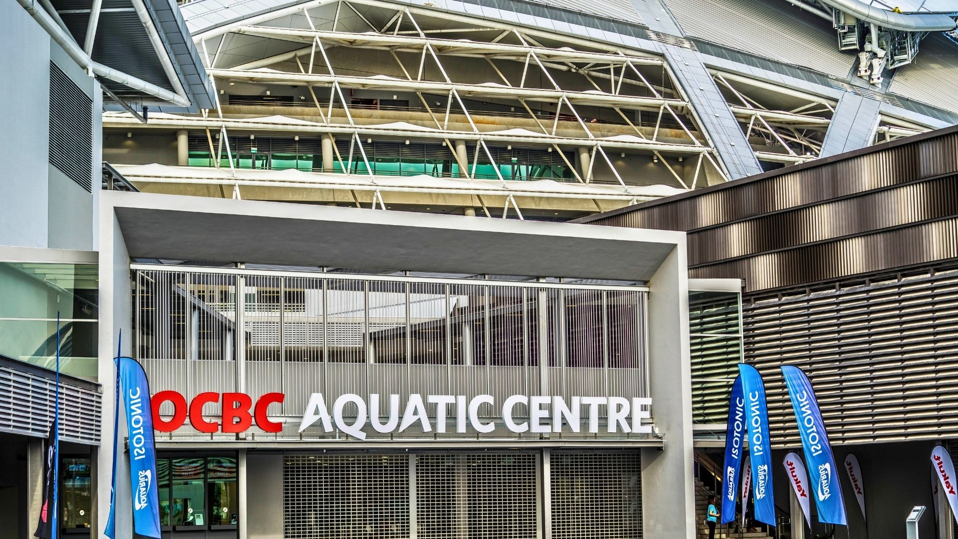 The entrance of the OCBC Aquatic Centre at Singapore Sports Hub/The Kallang. The acronym “OCBC” is in the bank's signature red colour.