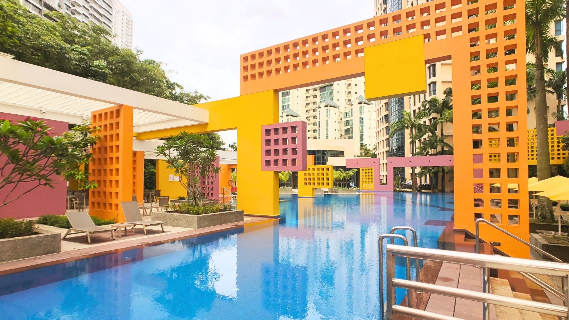 The newly-renovated swimming pool at Tanglin View Condominium in Singapore. The unique geometric concrete blocks in warm yellow and orange make it a recognisable feature of the residential property.