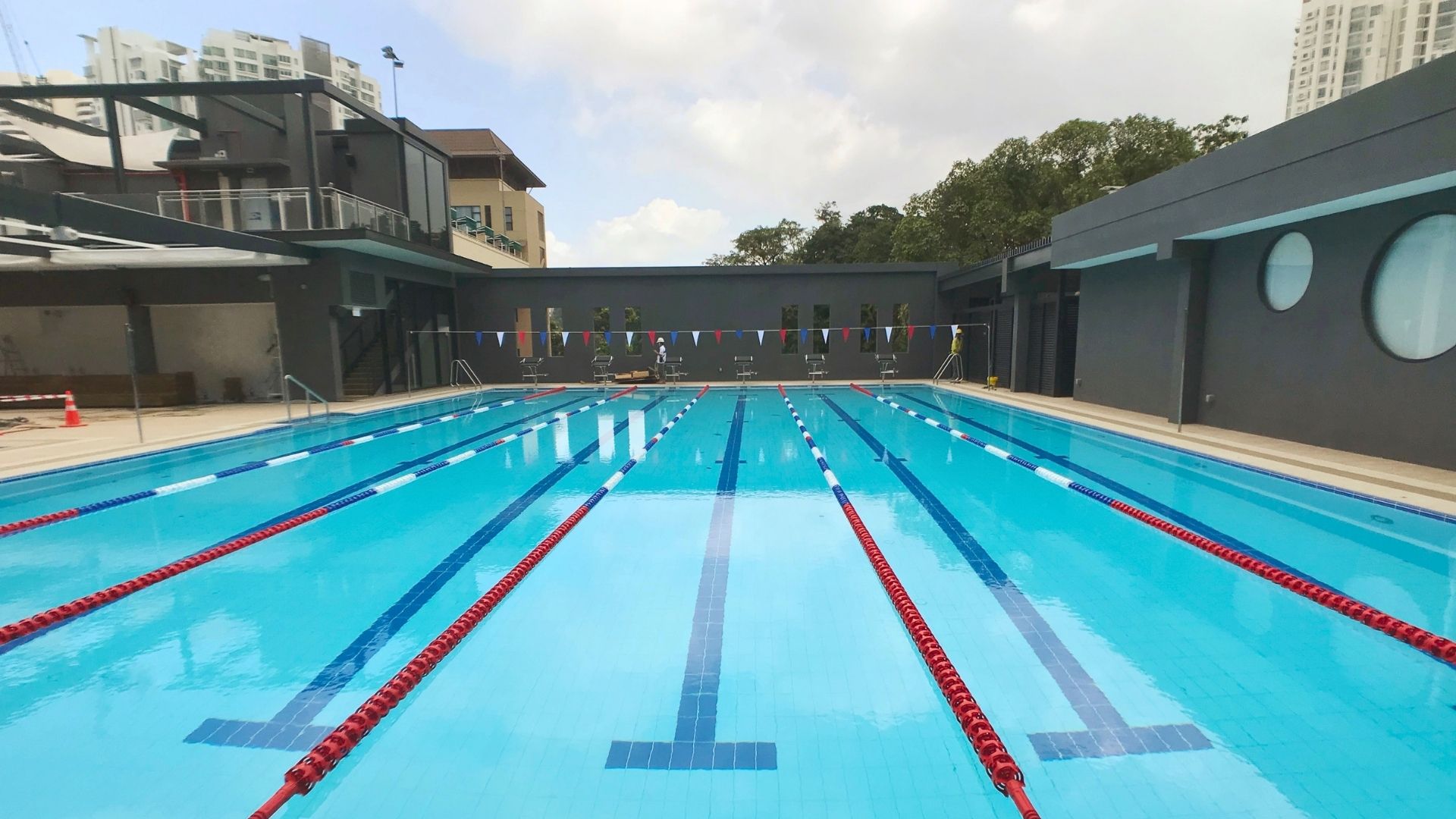Forward-facing view of the newly-renovated training pool at The American Club Singapore. It comes complete with essential pool equipment and accessories such as starting blocks, pool lane ropes, and backstroke poles.