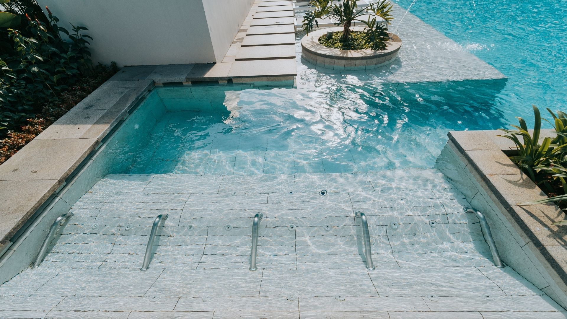 The jaccuzi lounge area at The Estuary Condominium in Yishun, Singapore. Hand rails are spaced out between the water jets.