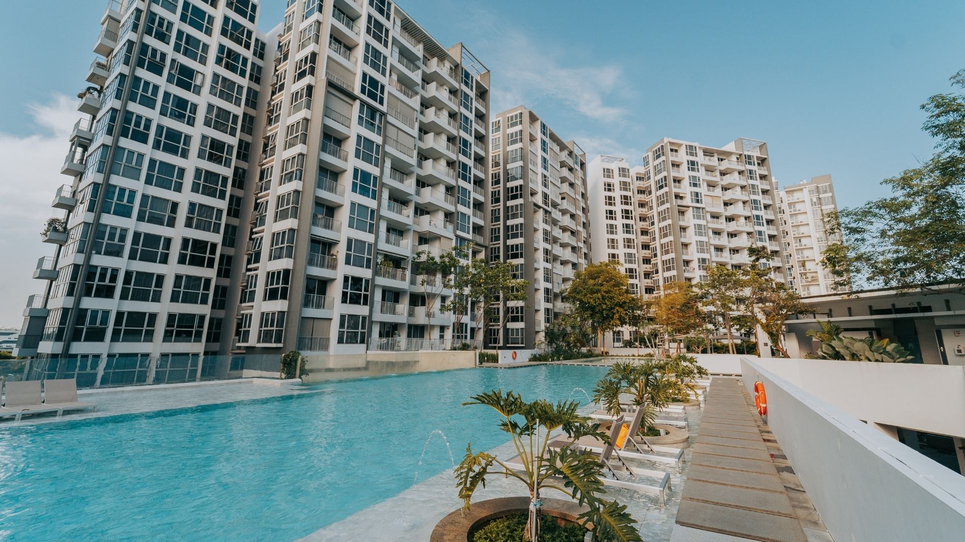 Concrete pool upgrade works completed for The Estuary Condominium in Yishun, Singapore. The 50-metre lap pool spans several residential blocks, with water fountain features and lush landscaping.