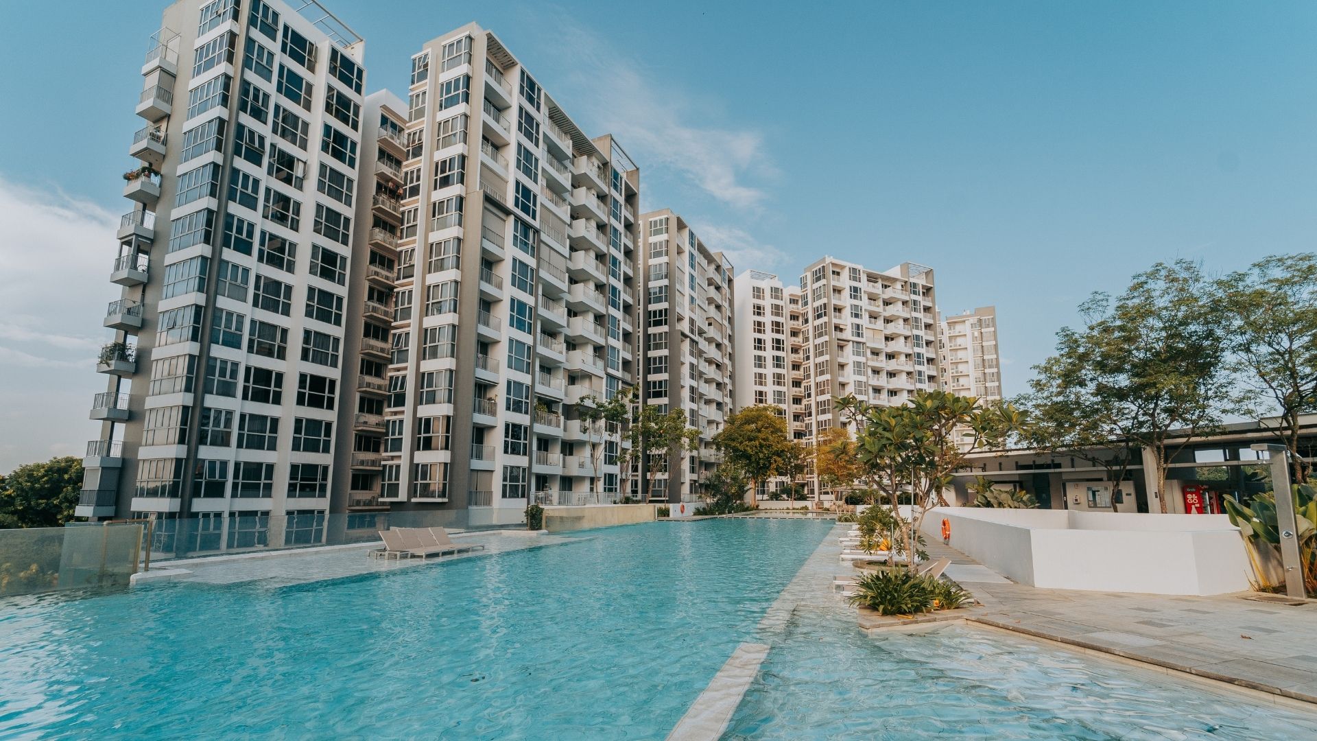 Swimming pool renovation works completed for The Estuary Condominium in Yishun, Singapore. The 50-metre lap pool stands out, with a triangular jaccuzi area at the corner. The pool deck looks spacious in the background.