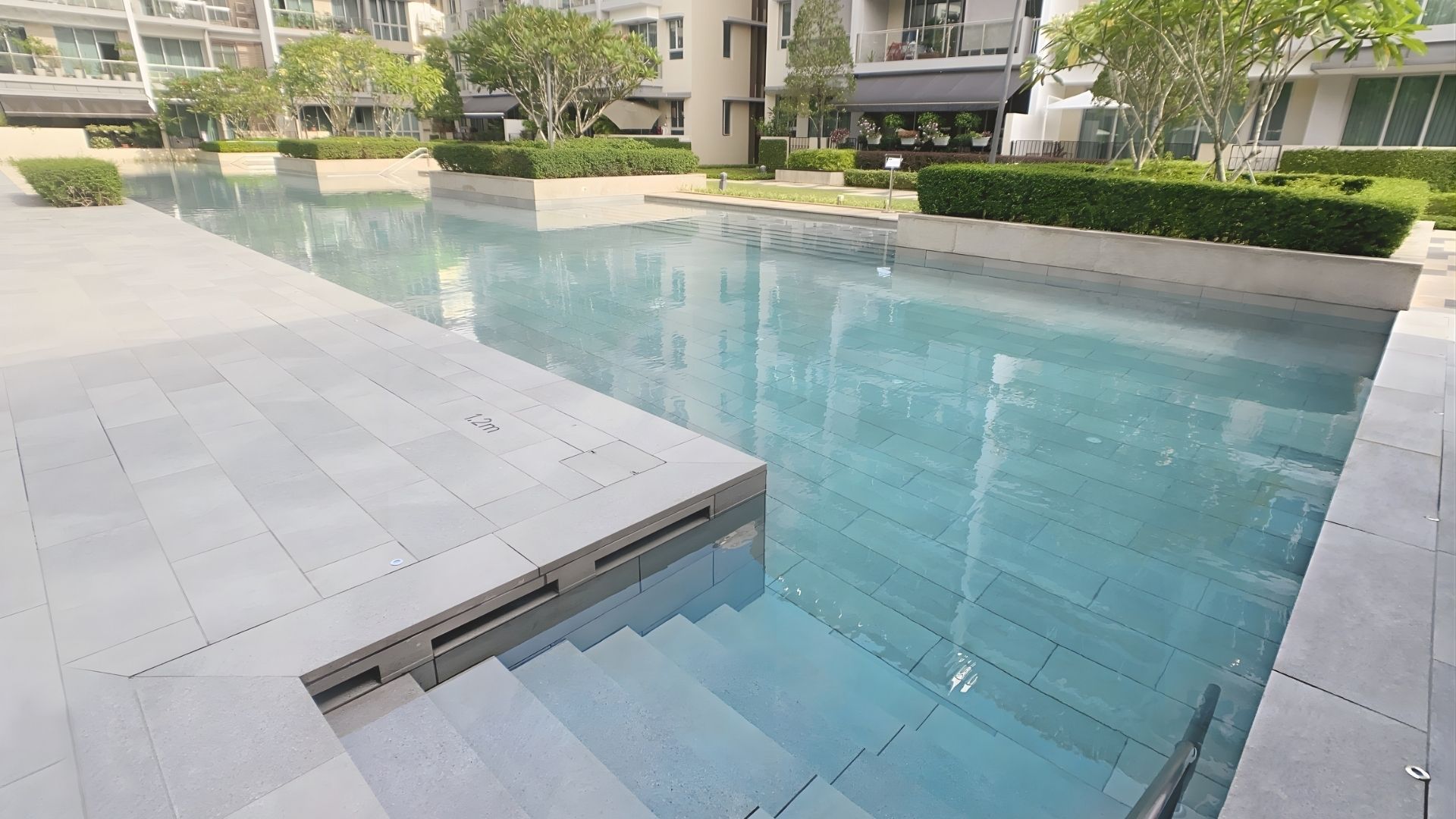 Close-up of the pool steps leading down into the swimming pool at The Glyndebourne Condominium in Singapore, made up of newly-laid Spanish large-format tiles.