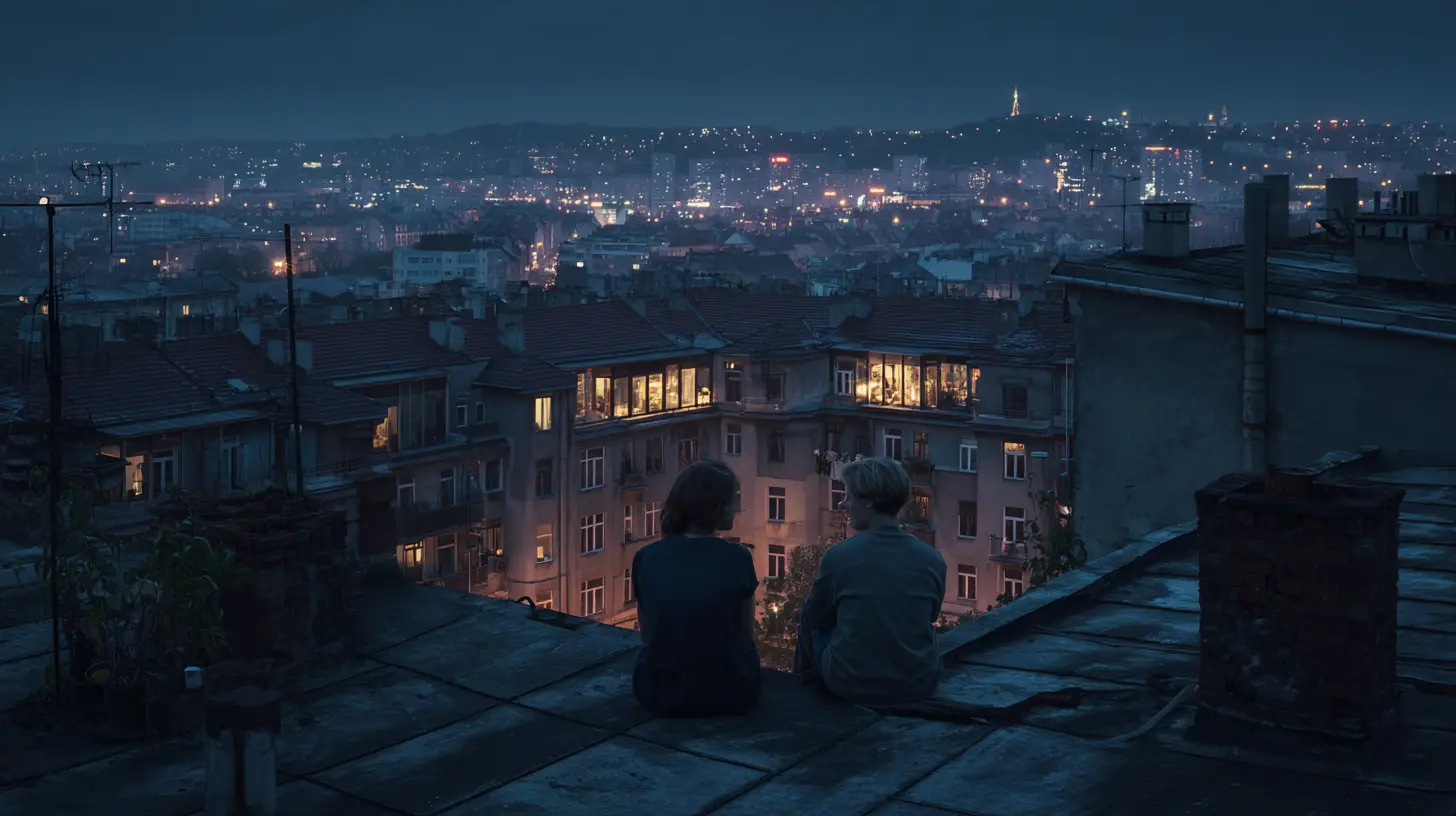 Two people sitting on a rooftop overlooking a cityscape illuminated at night.