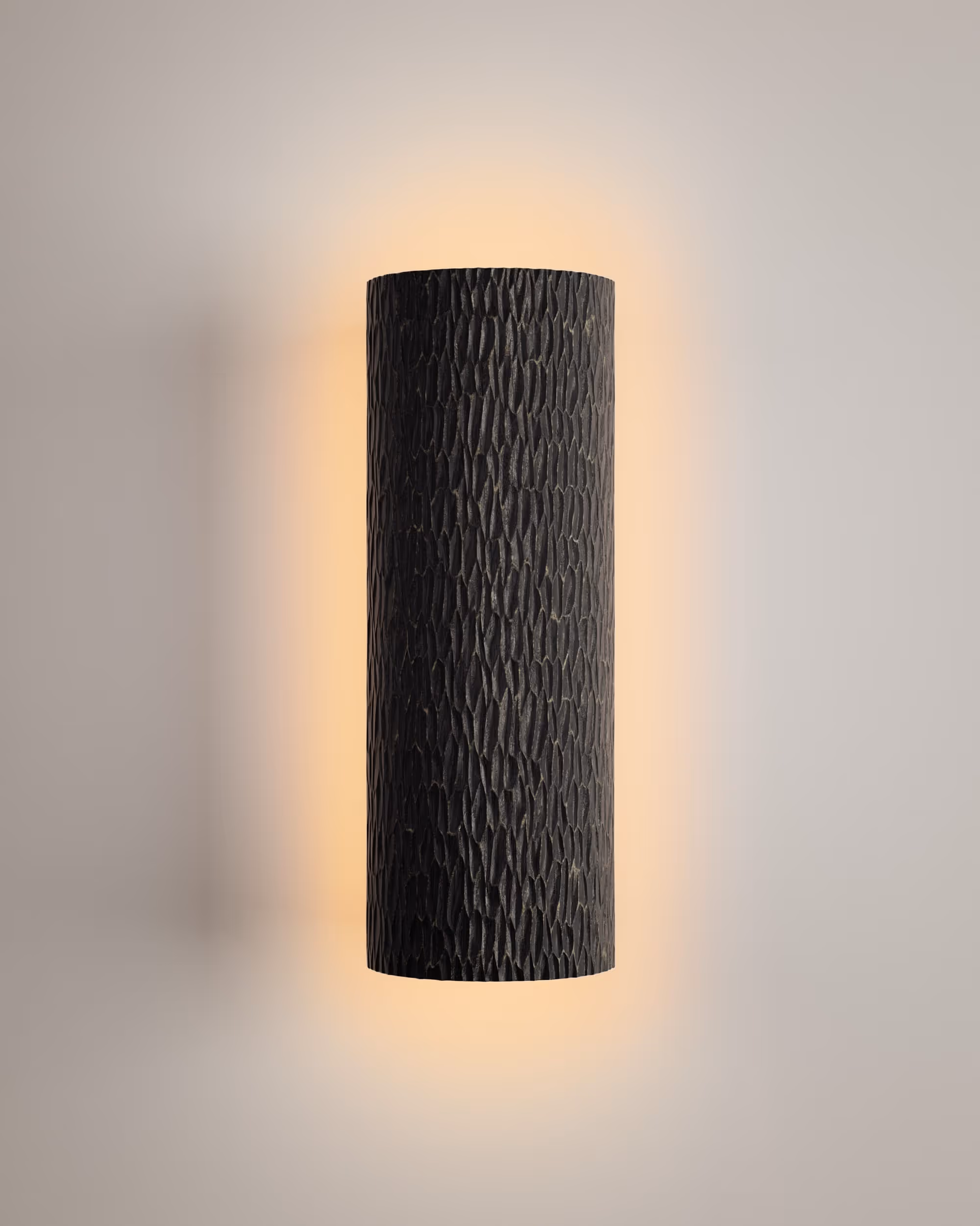 Kita Cast Sconce emitting warm light on a wooden panel background.